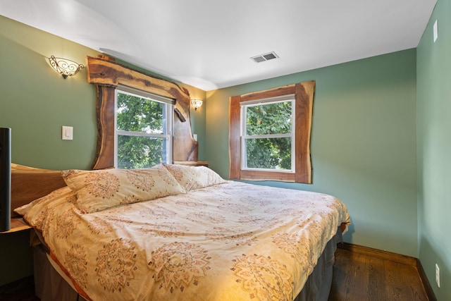 bedroom with dark wood-type flooring