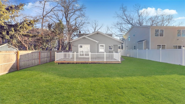 back of property featuring a lawn and a wooden deck