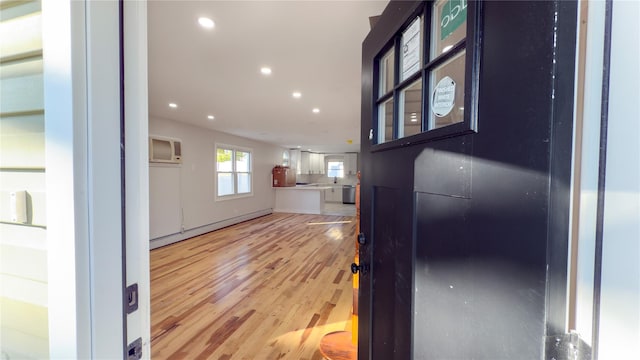 interior space with hardwood / wood-style floors and a baseboard heating unit