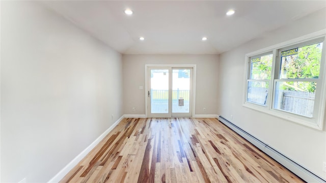 entryway featuring light wood-type flooring and a baseboard radiator