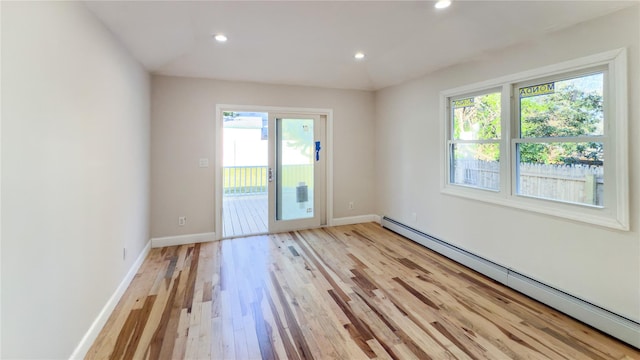 spare room featuring light hardwood / wood-style floors and baseboard heating