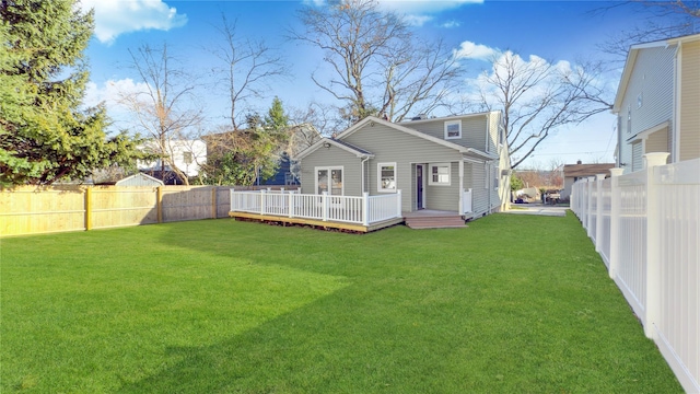 back of house with a yard and a deck