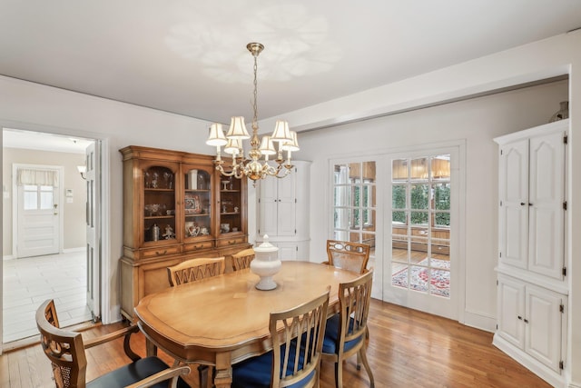 dining room featuring light hardwood / wood-style floors and a notable chandelier