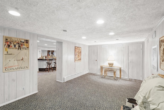 misc room with carpet flooring and wooden walls