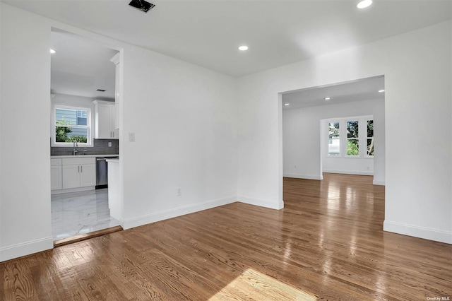 spare room with light hardwood / wood-style flooring and sink