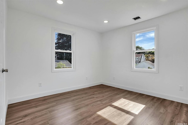 unfurnished room with hardwood / wood-style floors