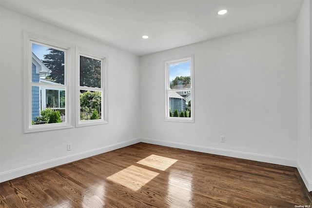 unfurnished room with dark hardwood / wood-style floors