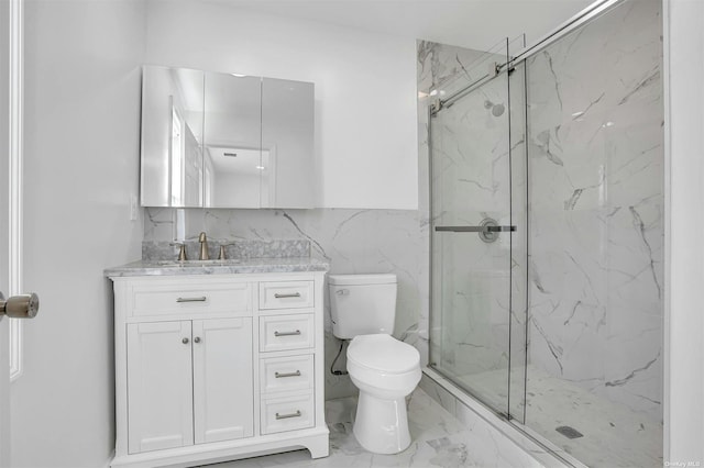 bathroom with vanity, toilet, an enclosed shower, and tile walls