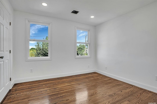 empty room with dark wood-type flooring