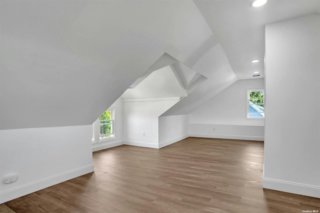 bonus room with wood-type flooring and lofted ceiling