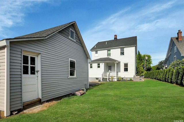 back of house featuring a yard