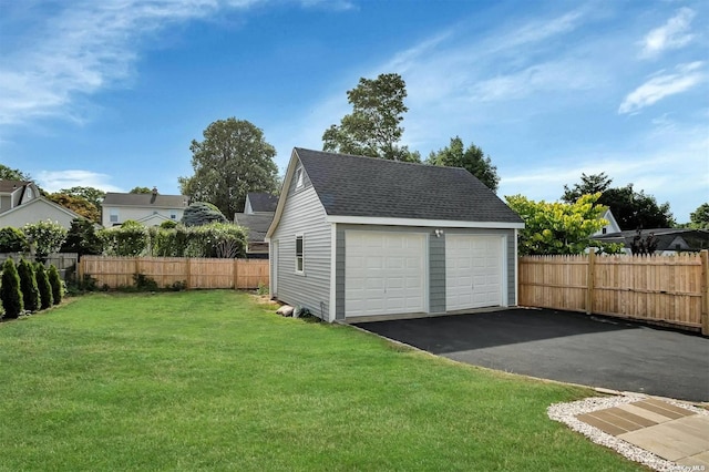 garage featuring a lawn