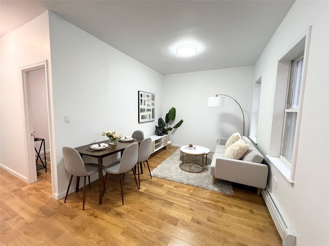 dining room with light hardwood / wood-style floors and baseboard heating