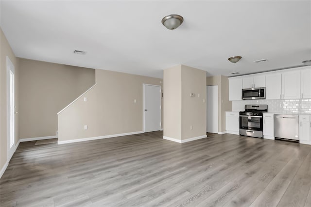 unfurnished living room with light hardwood / wood-style floors