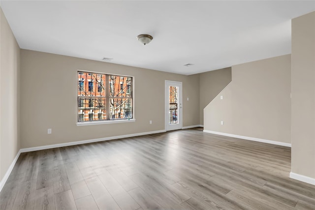 unfurnished room featuring light hardwood / wood-style floors