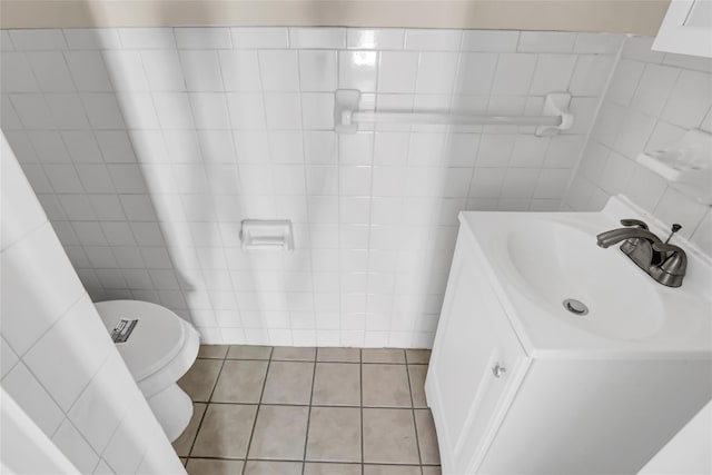 bathroom with tile patterned flooring, vanity, tile walls, and toilet