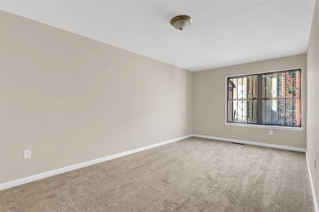 unfurnished room featuring carpet