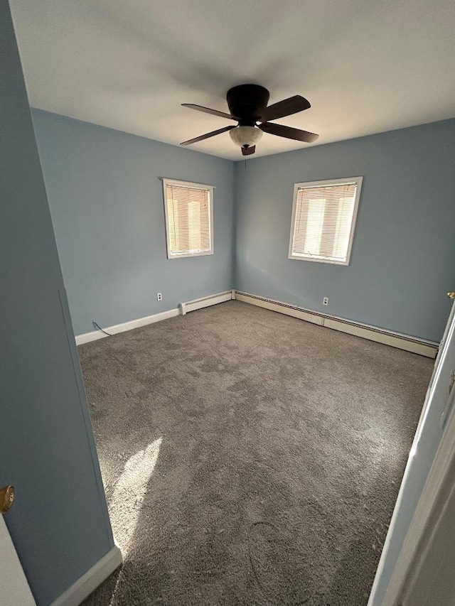 carpeted empty room featuring a baseboard heating unit and ceiling fan