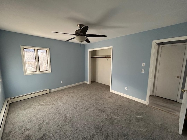 unfurnished bedroom featuring a baseboard heating unit, ceiling fan, and carpet floors