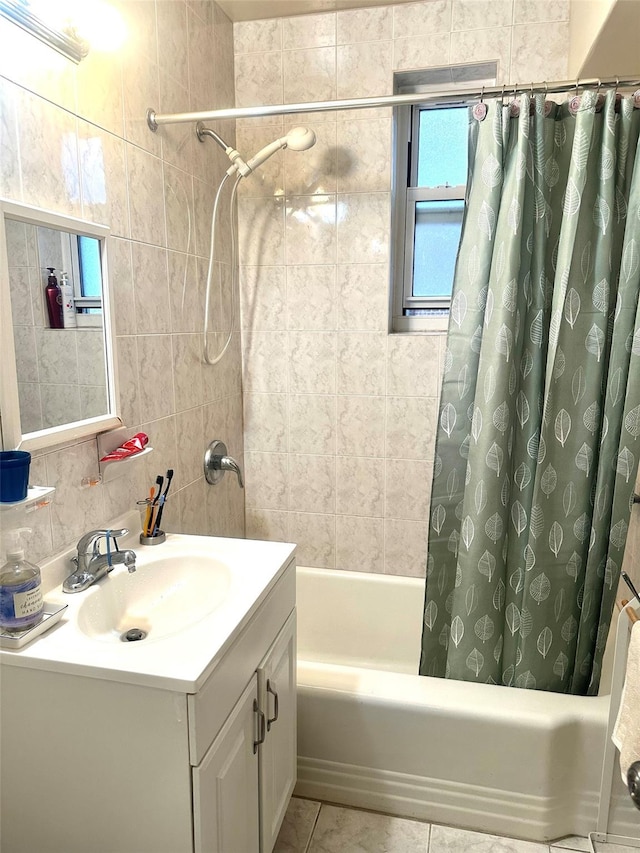 bathroom with tile patterned flooring, vanity, shower / tub combo with curtain, and tile walls