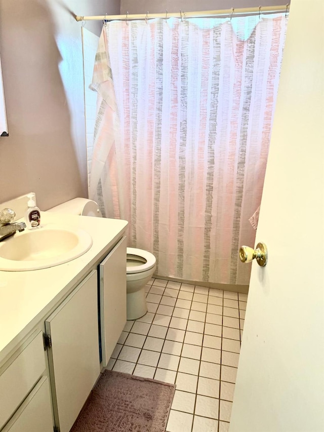 bathroom featuring vanity, tile patterned floors, and toilet