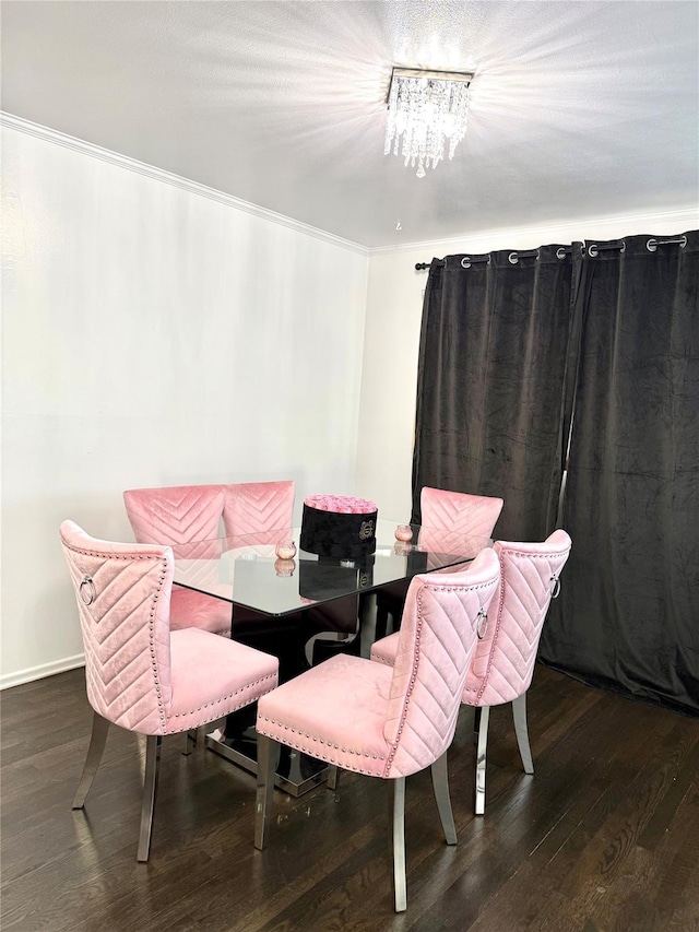 dining room featuring ornamental molding, dark hardwood / wood-style flooring, and a chandelier