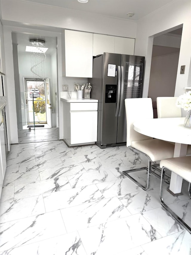 kitchen featuring stainless steel fridge with ice dispenser and white cabinets