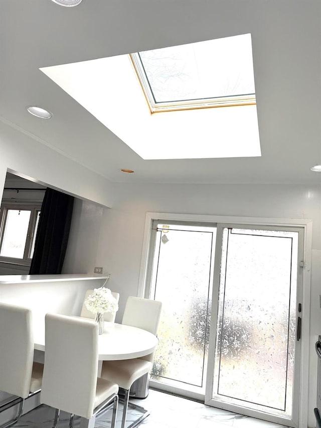 dining room featuring a skylight