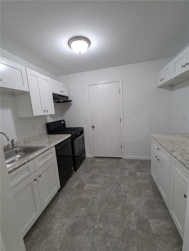 kitchen with light stone countertops, white cabinetry, sink, and black appliances