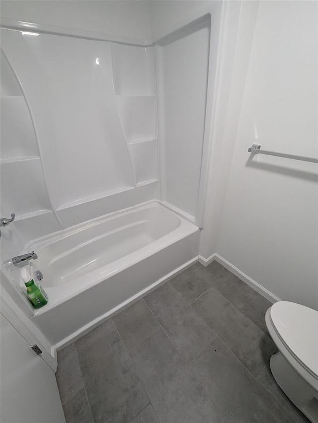 bathroom featuring shower / bathtub combination and toilet