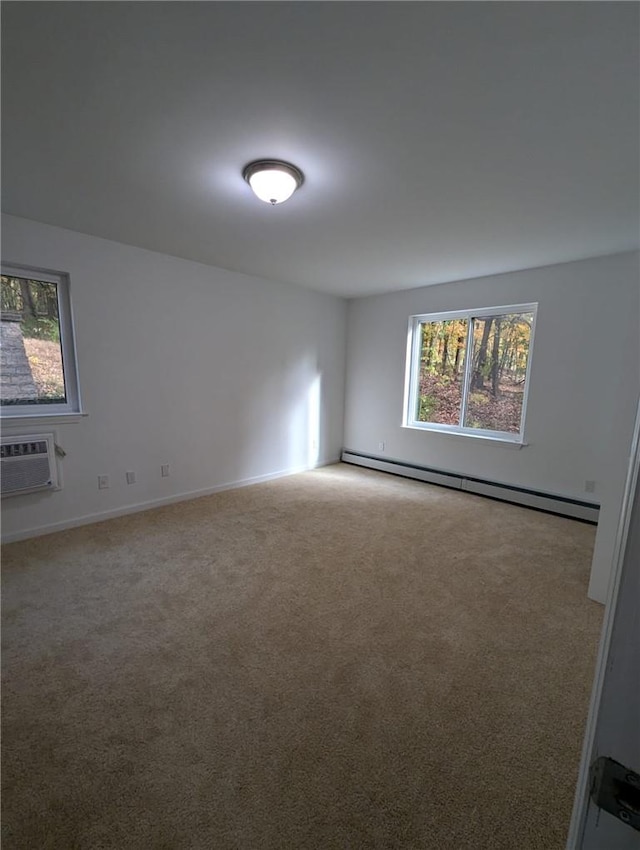 carpeted spare room featuring a wall mounted air conditioner and a baseboard radiator