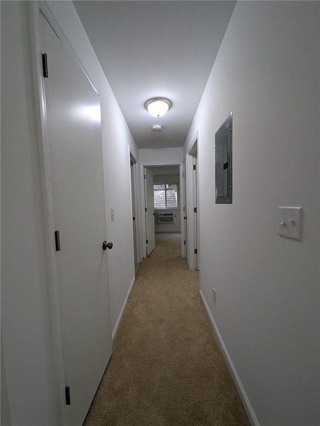 hallway with light colored carpet and electric panel