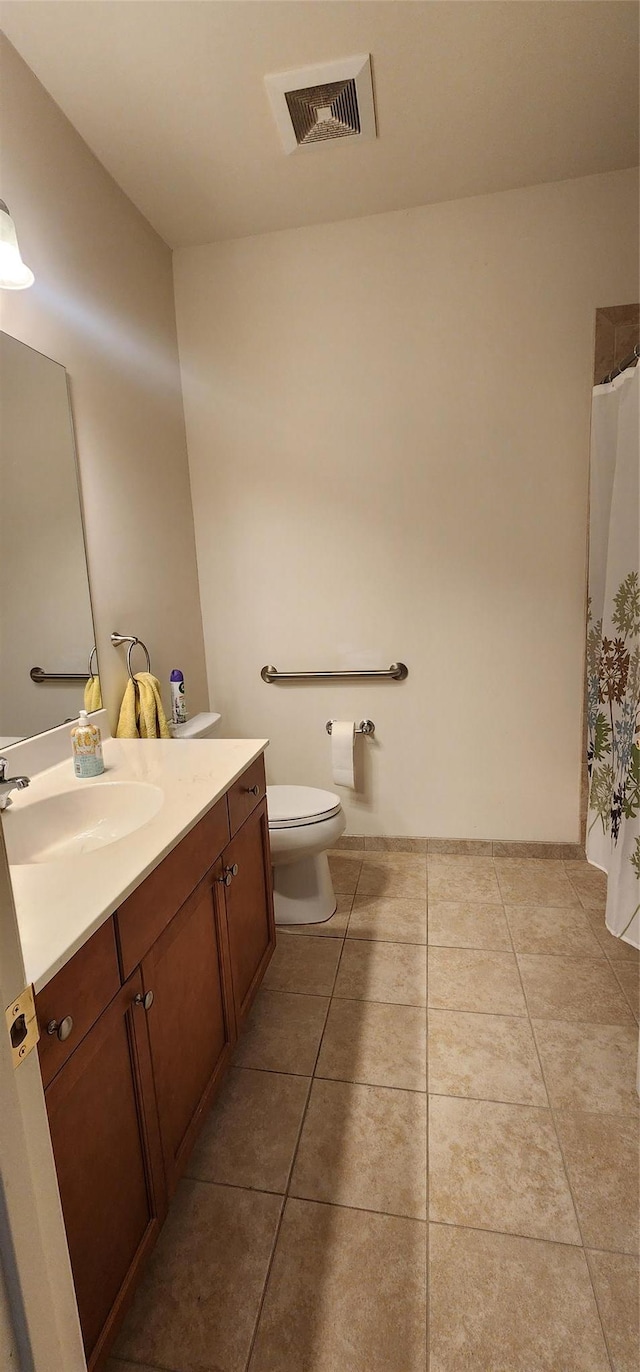 bathroom featuring tile patterned floors, vanity, and toilet