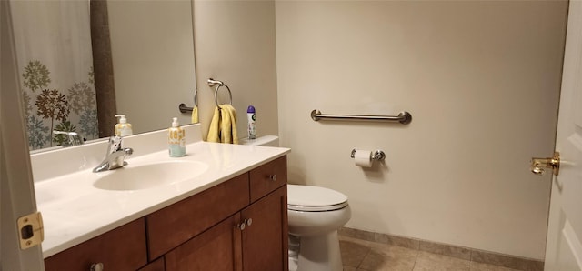 bathroom with tile patterned flooring, vanity, and toilet