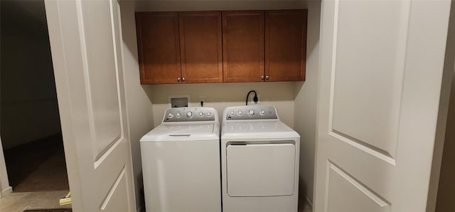 laundry room featuring cabinets and washing machine and dryer