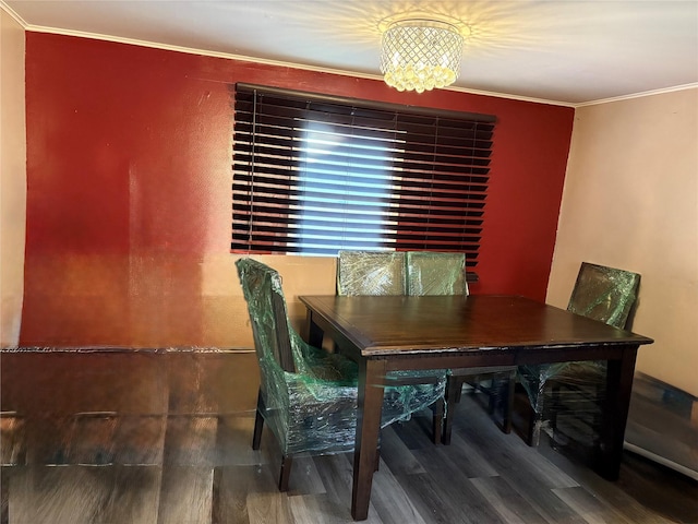 dining space featuring a chandelier, hardwood / wood-style flooring, and crown molding