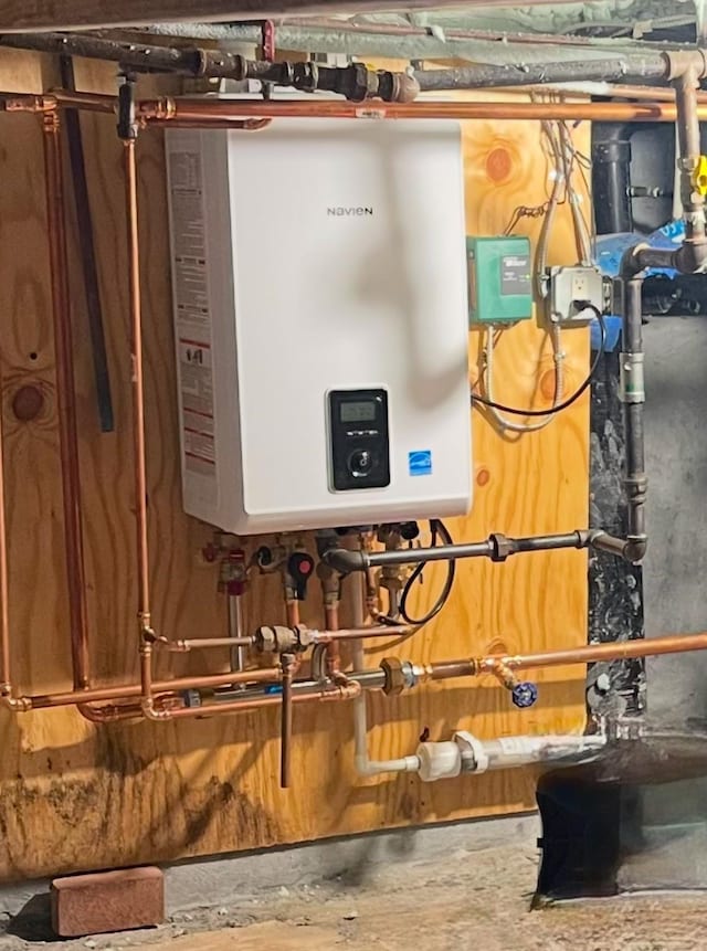 utility room with tankless water heater