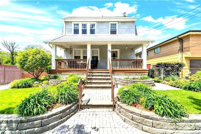 view of front of home with covered porch and a front yard