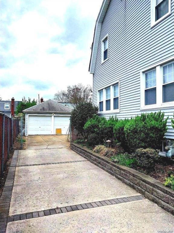 view of side of property featuring a garage and an outdoor structure