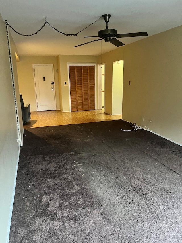 unfurnished living room with ceiling fan