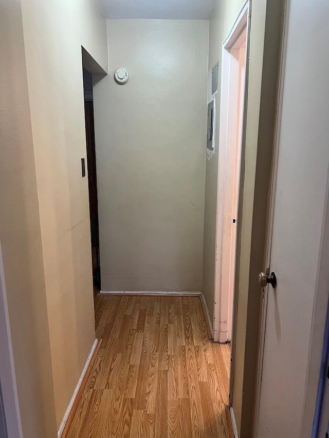 corridor with light hardwood / wood-style floors