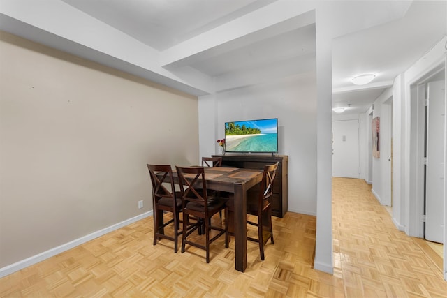 dining space featuring light parquet flooring