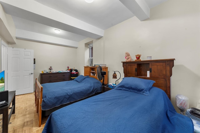 bedroom with beam ceiling and light parquet floors