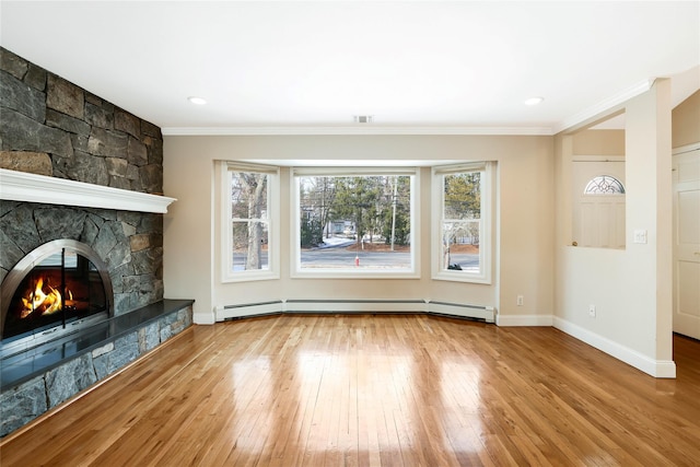 unfurnished living room featuring a stone fireplace, light wood-type flooring, ornamental molding, and a baseboard heating unit