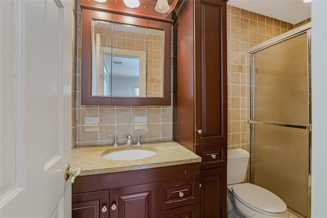 bathroom featuring backsplash, walk in shower, vanity, tile walls, and toilet