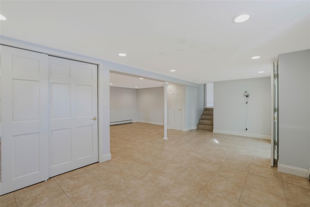 basement with light tile patterned floors and a baseboard radiator