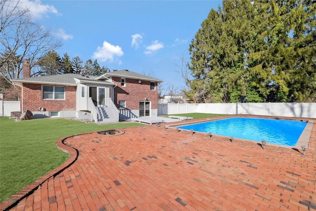 view of swimming pool featuring a patio, a diving board, and a lawn