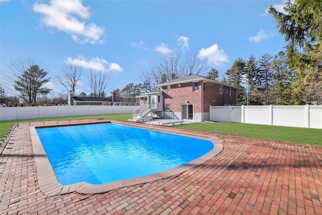 view of pool featuring a deck, a yard, and a patio