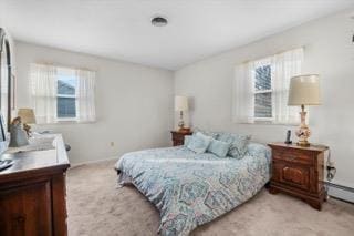 carpeted bedroom featuring a baseboard radiator and multiple windows