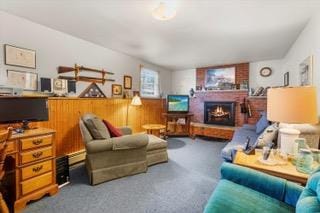 living room with wooden walls and a fireplace